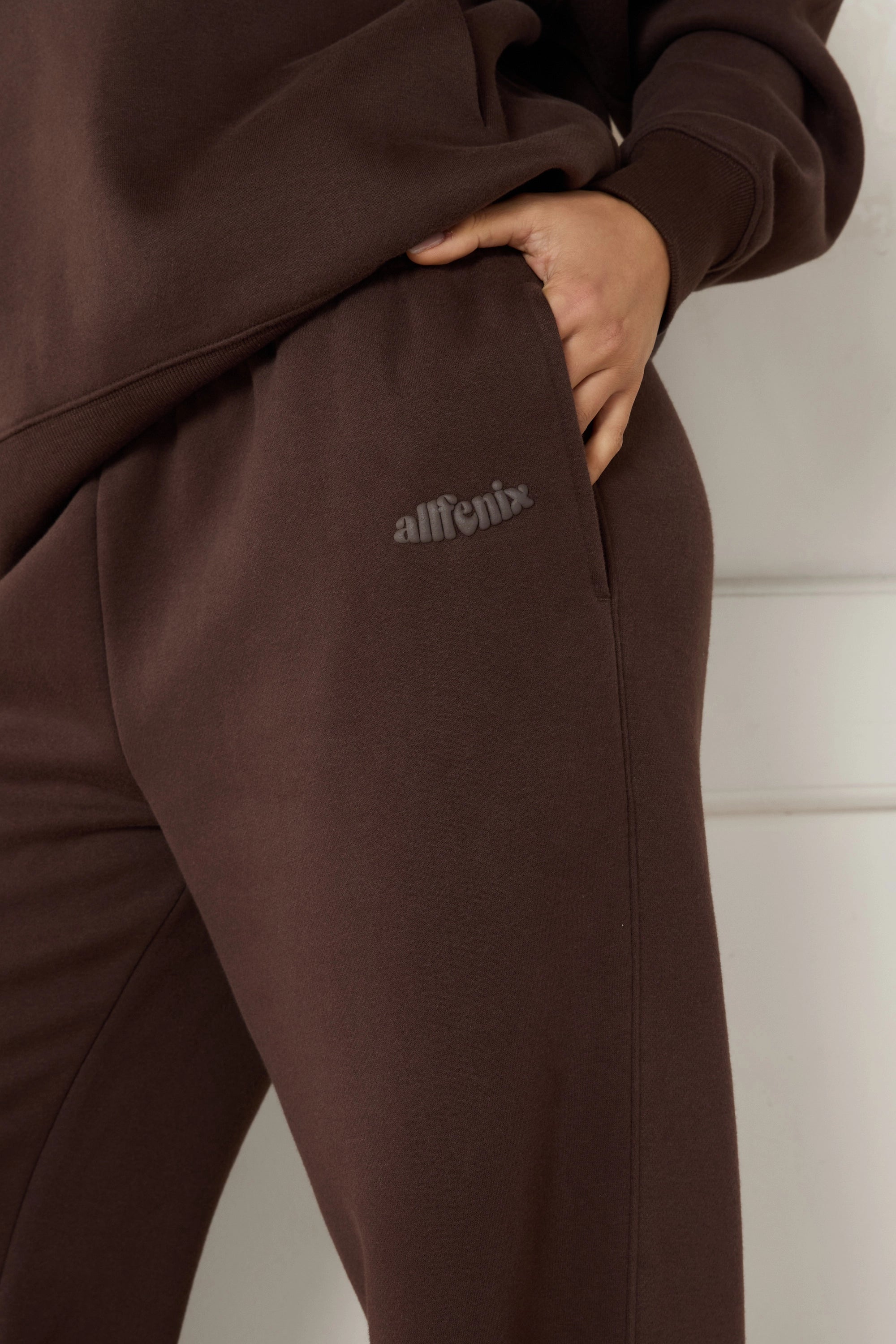Espresso brown tracksuit with 'ALLFENIX' branding on a plain background