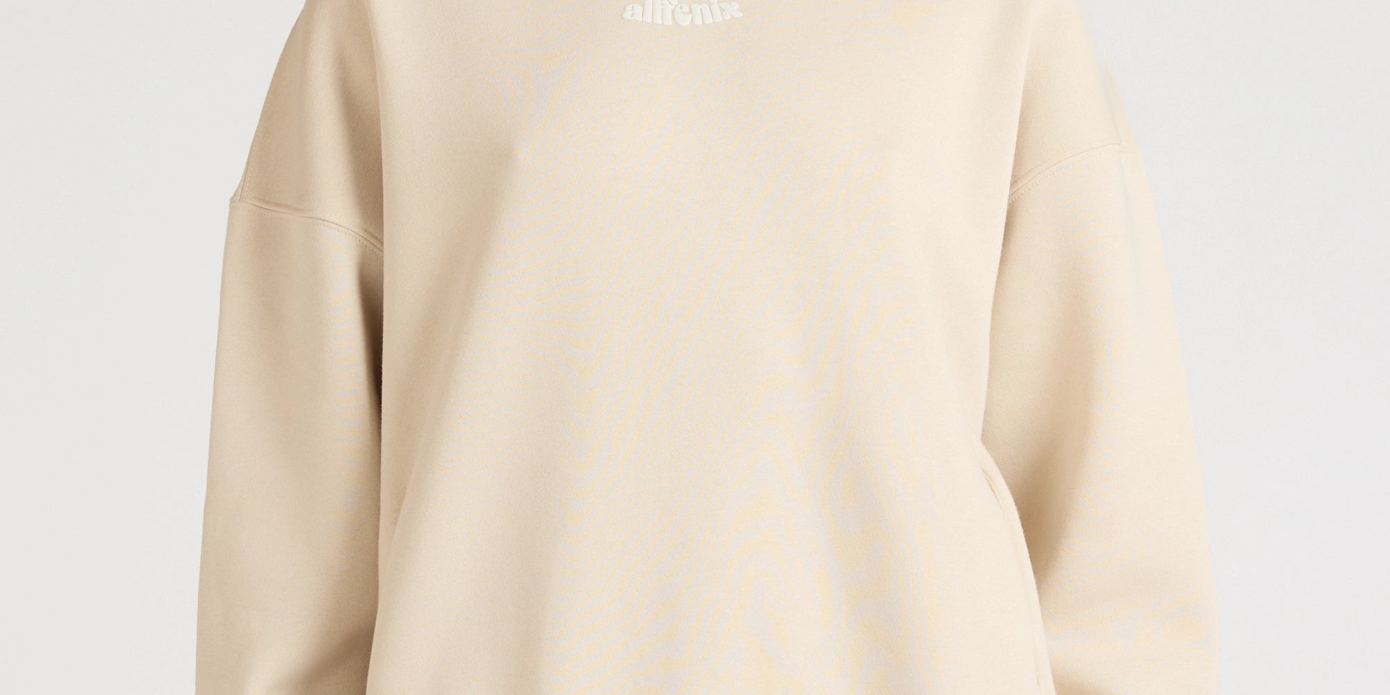 Woman wearing a beige hoodie and pants on a white background