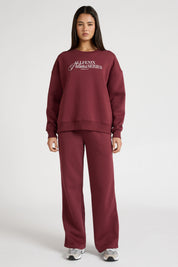 Woman wearing a maroon sweatshirt with 'All Fenix Pilates Series' text on a white background