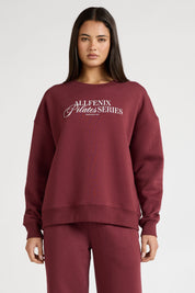 Woman wearing a maroon sweatshirt with 'All Fenix Pilates Series' text on a white background
