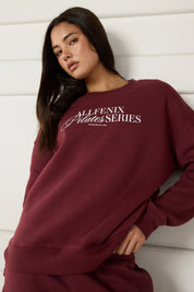 Woman wearing a maroon sweatshirt with 'All Fenix Pilates Series' text on a white background