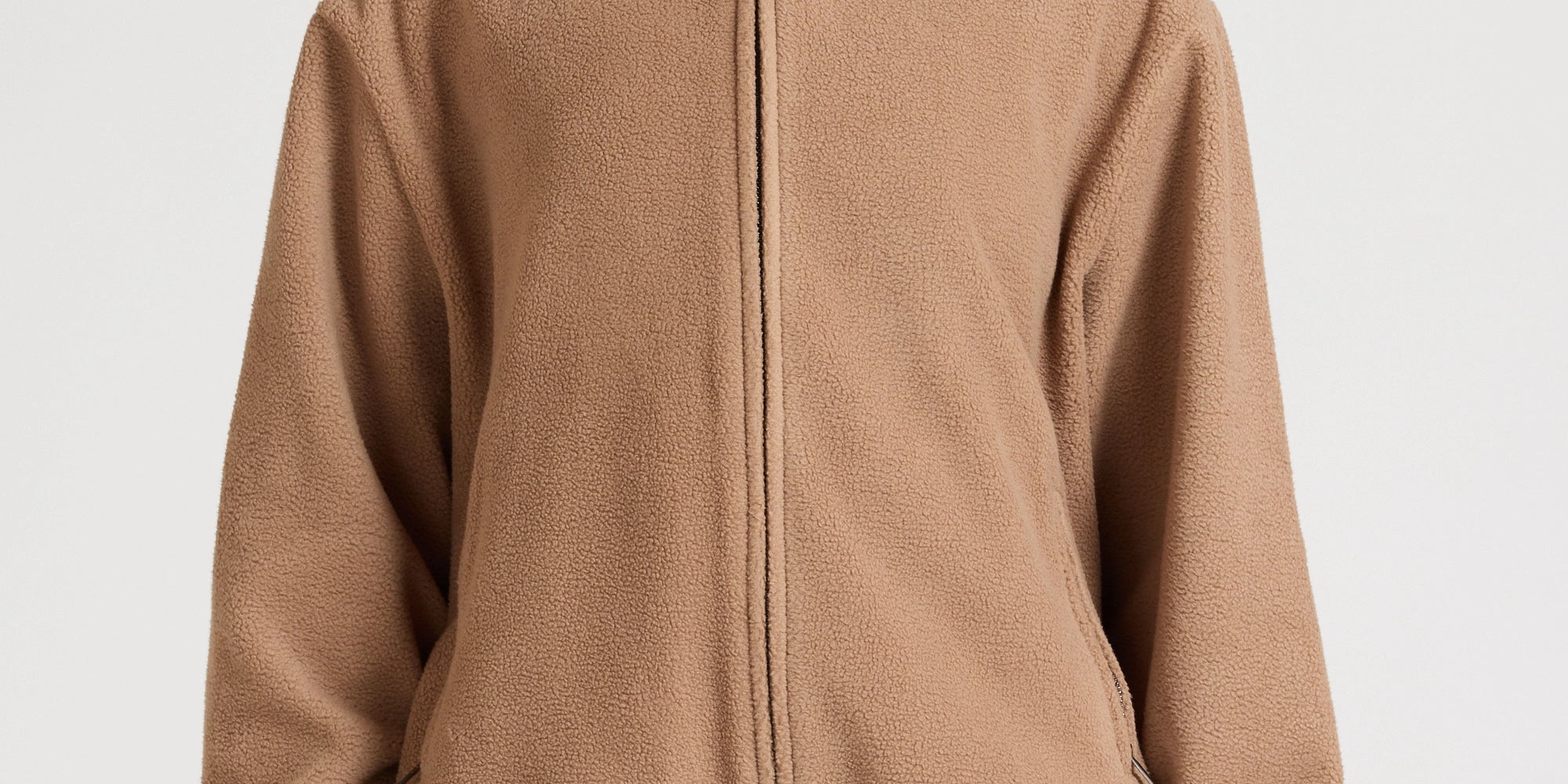 Woman wearing a brown fleece jacket and shorts on a white background